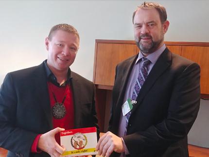 Mike Hogeterp, right, was able to share postcards signed by University of Ottawa students advocating for improved education for Indigenous people in Canada.