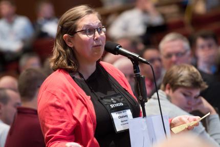 Chelsey Harmon urged delegates to pray and advocate for immigrants.