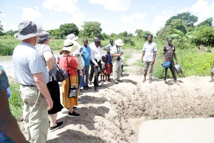 Participants of the Climate Witness Project Bootcamp - East Africa trip learn from farmers in Uganda about how they are adapting to climate change. 