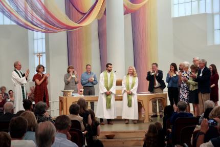 Andrew Mead and Karen Campbell receive applause following their installation.