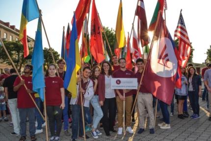LCC students hold flags representing their countries.