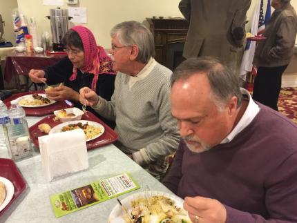 Jack Roeda (center) shares a meal at the Islamic Mosque and Religious Institute 