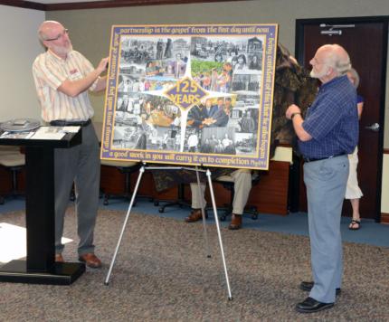 Steve Van Zanen and artist Sy Ellens unveil the anniversary painting