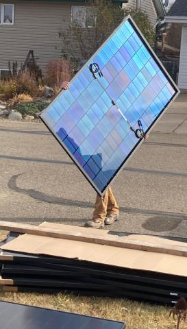 A person carrying a solar panel