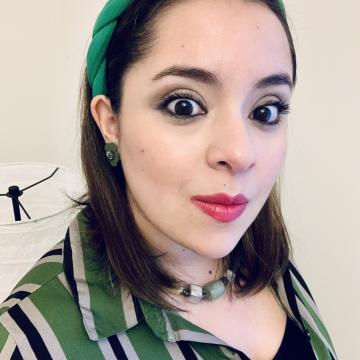 Woman with dark hair wearing green and black striped shirt